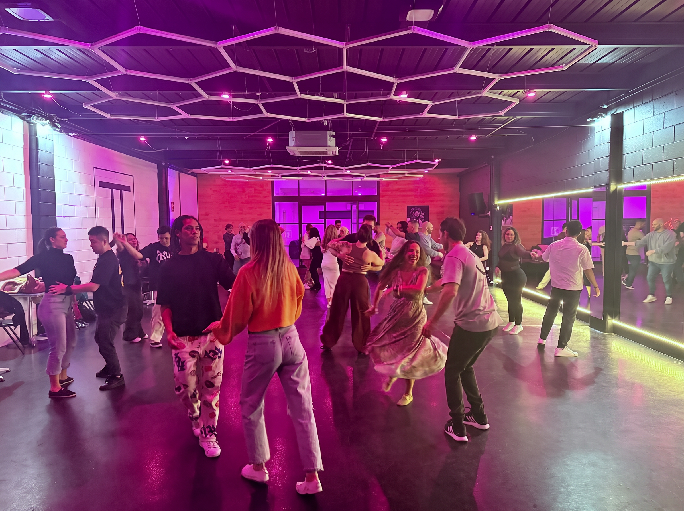 Adults social dancing under hexagon lights at JT Dance Academy in Southport, Gold Coast